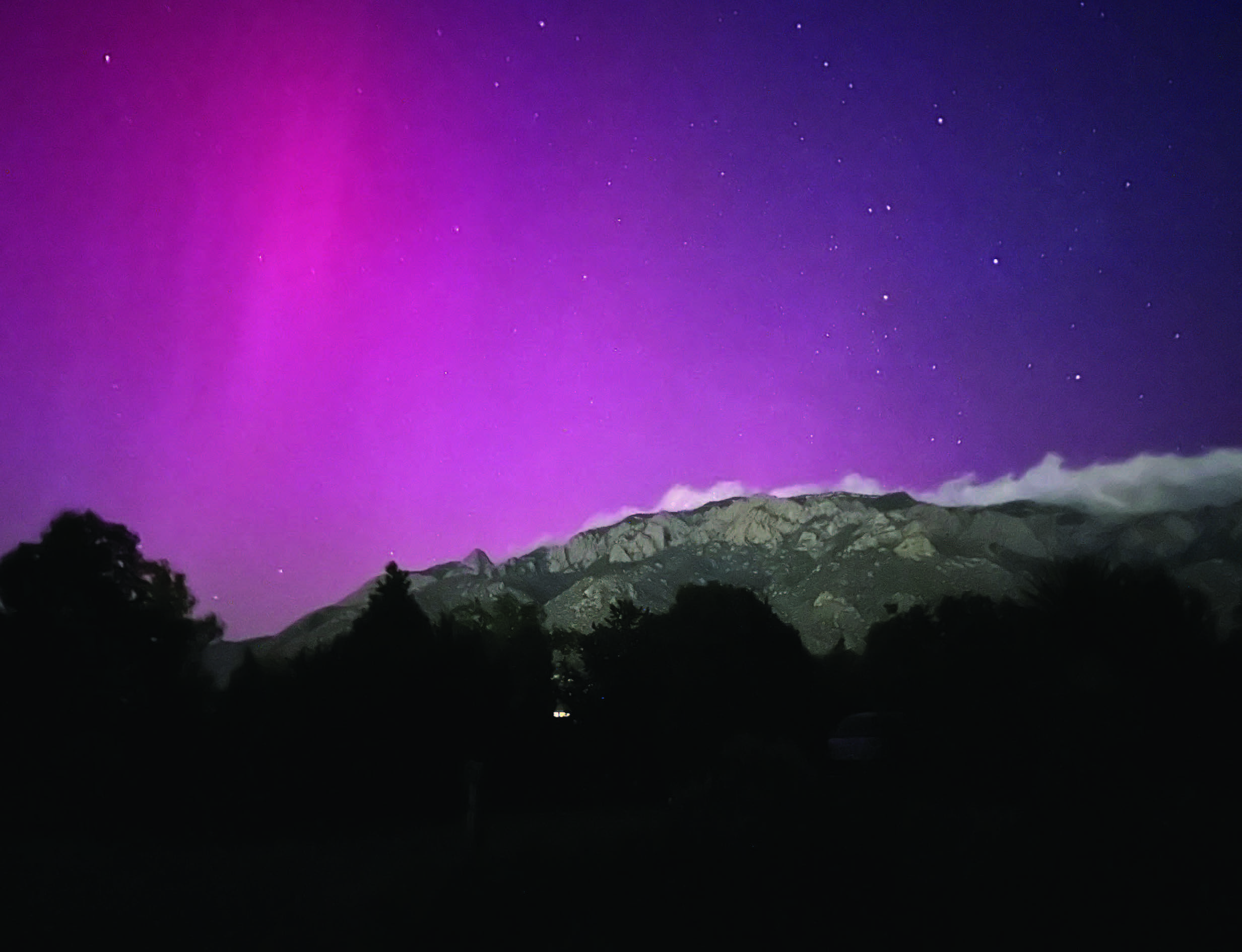 The aurora display glows shortly after midnight over the Sandia Mountains east of Albuquerque on May 11, 2024. PHOTO COURTESY OF MARK BOSLOUGH
