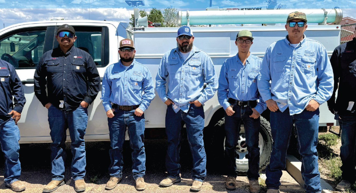 Navajo Tribal Utility Authority and Columbus Electric Cooperative crew members work together to bring electricity to remote homes in Navajo Nation as part of the Light Up Navajo initiative. From left: Leander Begay, NTUARM journeyman lineworker; Leo Kayanni, NTUASR foreman; Porter Howard, CEC journeyman lineworker; Daniel Lopez, CEC line superintendent; Colton Villegas, CEC apprentice lineworker; Frankie Gonzales, CEC apprentice lineworker; and Leander Black, NTUAKY journeyman lineworker.