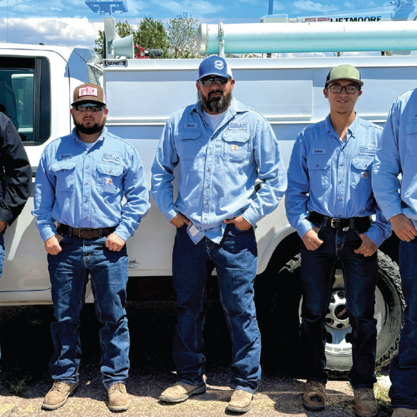 Navajo Tribal Utility Authority and Columbus Electric Cooperative crew members work together to bring electricity to remote homes in Navajo Nation as part of the Light Up Navajo initiative. From left: Leander Begay, NTUARM journeyman lineworker; Leo Kayanni, NTUASR foreman; Porter Howard, CEC journeyman lineworker; Daniel Lopez, CEC line superintendent; Colton Villegas, CEC apprentice lineworker; Frankie Gonzales, CEC apprentice lineworker; and Leander Black, NTUAKY journeyman lineworker.
