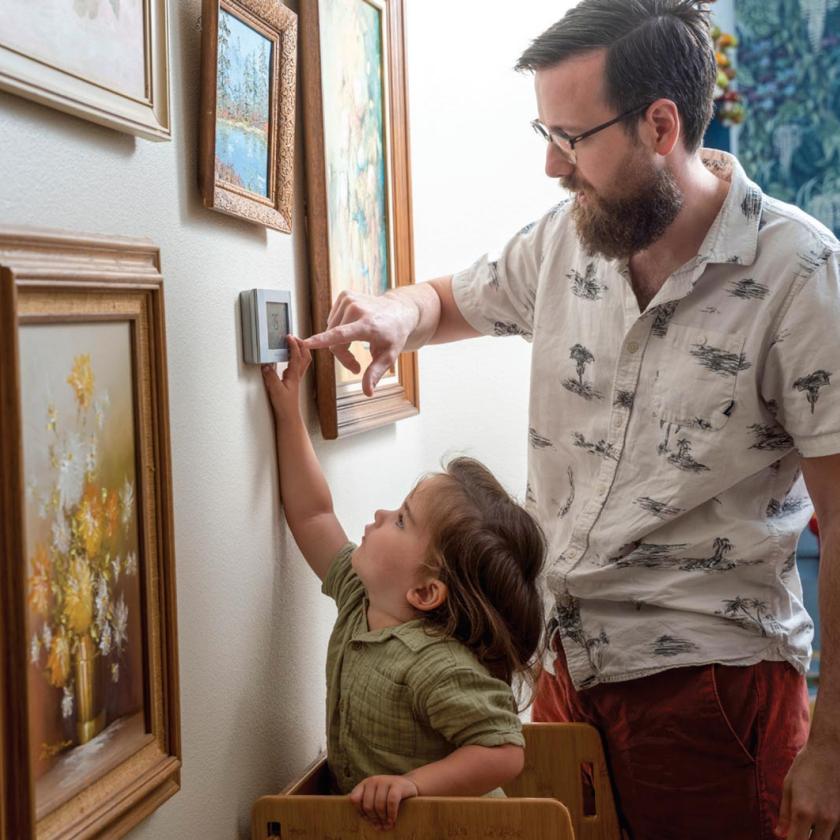 Father & Son adjusting thermostat together